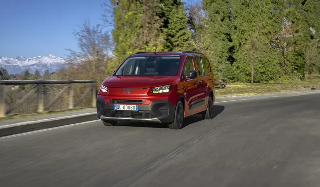 Nuovo Fiat QUBO L rosso che viaggia su una strada di montagna