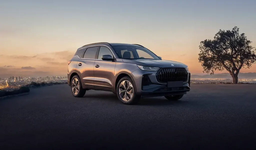 nuova dr 6, parcheggiata su uno spiazzo con una metropoli al tramonto sullo sfondo